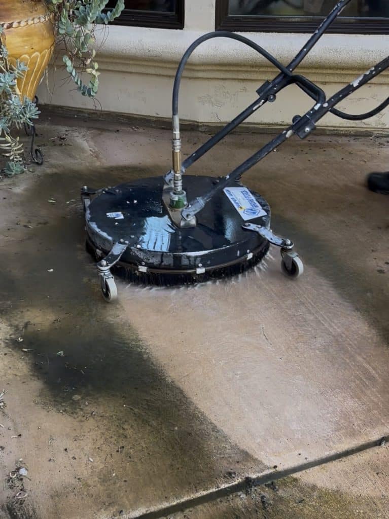 Patio Concrete Cleaning with pressure washing surface cleaner.